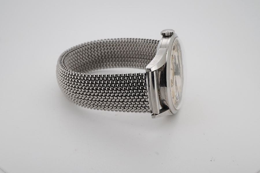 A gentleman's stainless steel Longines manual wind wrist watch, with baton and quarterly Arabic numerals and subsidiary seconds, case diameter 35mm, on an associated flexible strap.